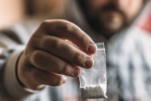Man Holding the cocaine in a packet