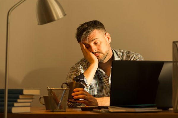 Sleepy man at computer